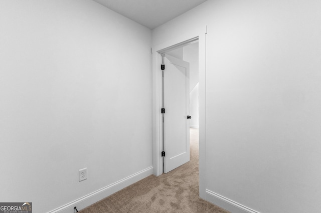 hall with light colored carpet