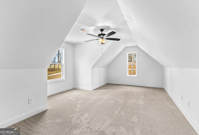 bonus room with ceiling fan, vaulted ceiling, and light carpet