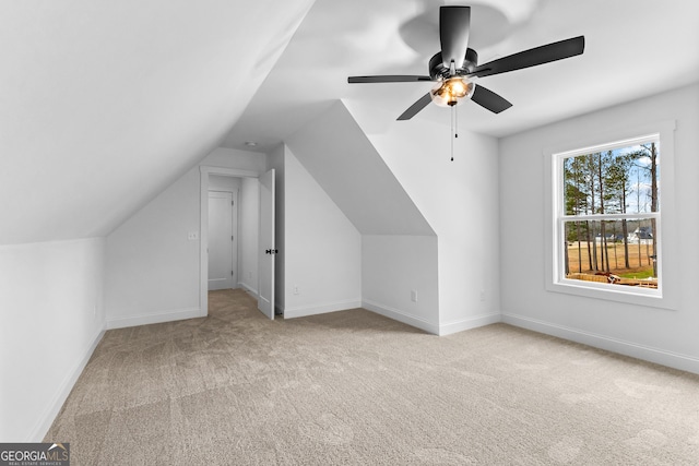 additional living space featuring light carpet, vaulted ceiling, and ceiling fan