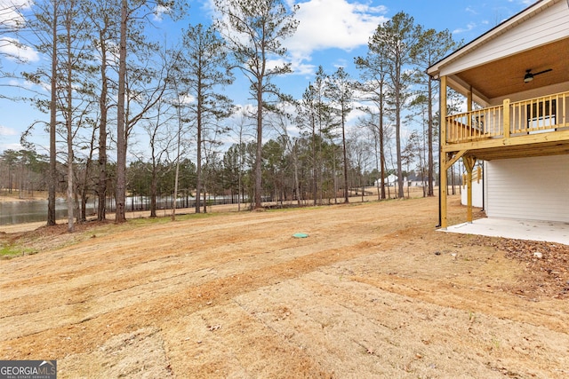 view of yard with ceiling fan and a patio area