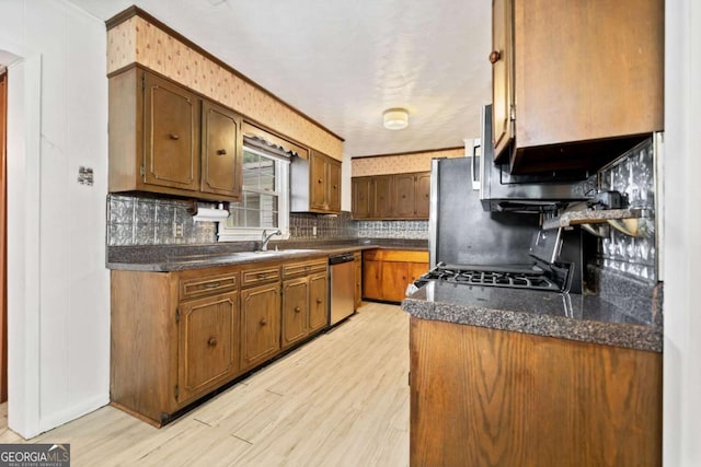 kitchen with range, light hardwood / wood-style flooring, ornamental molding, dishwasher, and backsplash