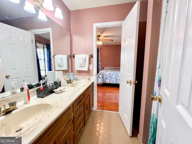 bathroom featuring ceiling fan, vanity, and tile patterned flooring