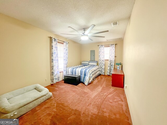 bedroom with ceiling fan, carpet flooring, electric panel, and a textured ceiling