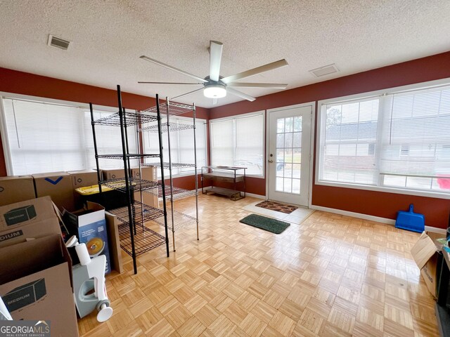 sunroom / solarium featuring ceiling fan