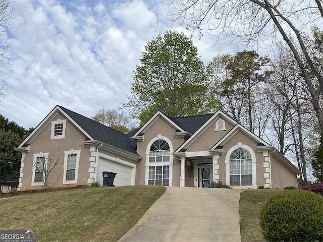 view of front of house with a front yard and a garage