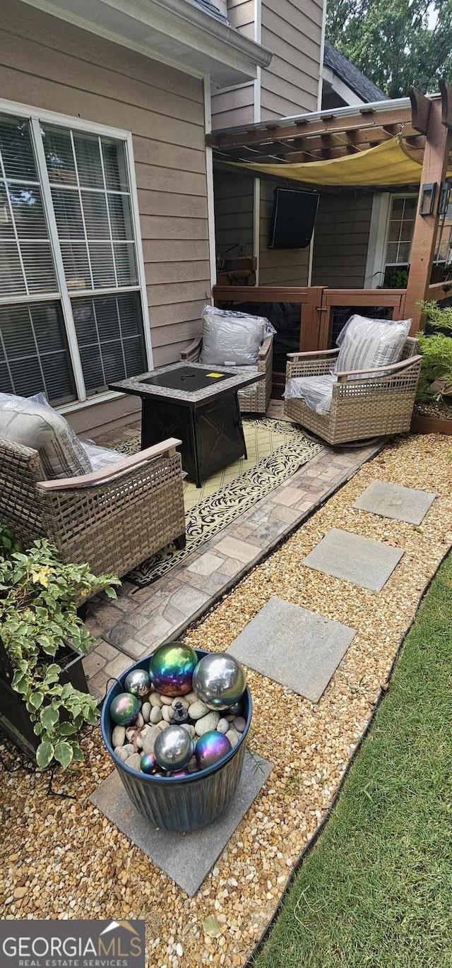 view of patio / terrace with an outdoor fire pit