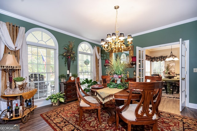 dining area with an inviting chandelier, ornamental molding, and wood-type flooring