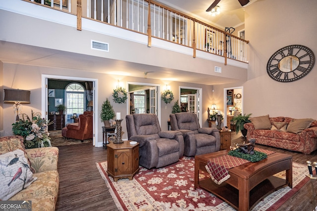 living room with dark hardwood / wood-style floors and a high ceiling