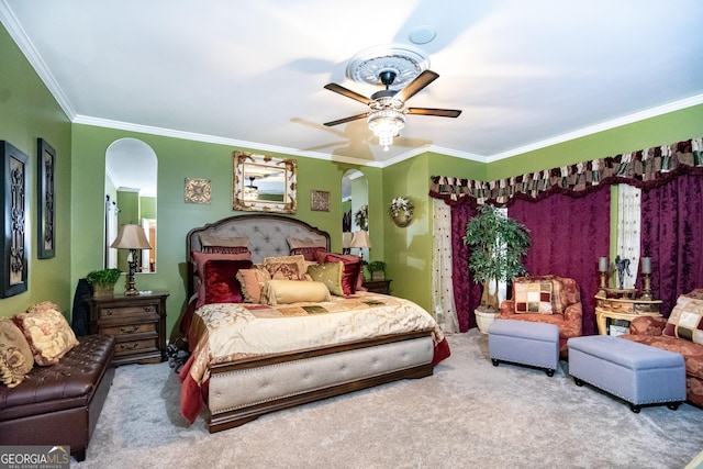 carpeted bedroom with ornamental molding and ceiling fan