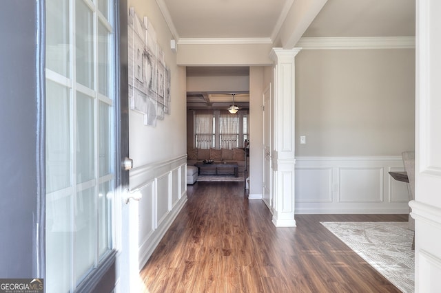 corridor featuring ornate columns, crown molding, and dark hardwood / wood-style flooring