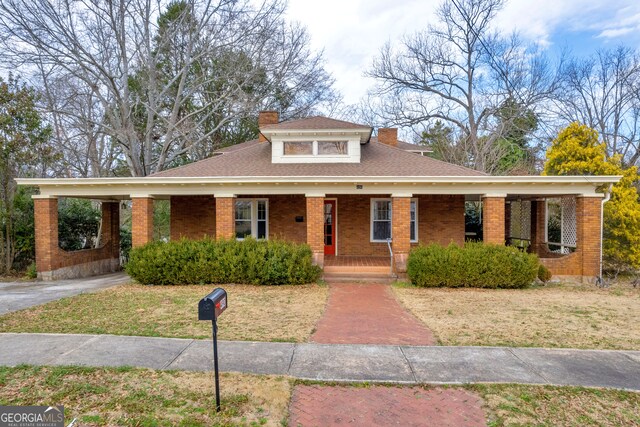 490 College St, Royston, GA 30662 - view of front facade with a chimney, covered porch, brick siding, and a front yard