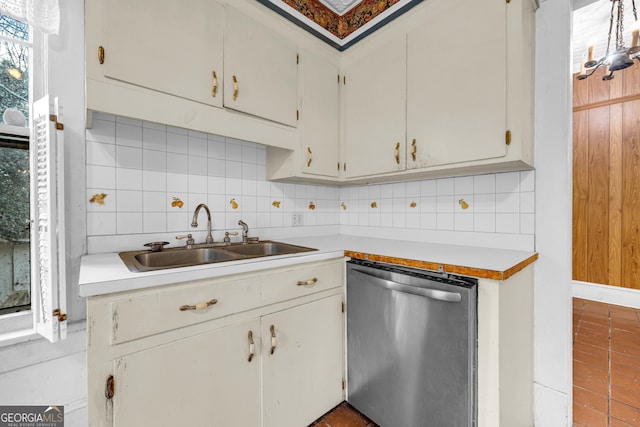 kitchen with white cabinets, stainless steel dishwasher, sink, and backsplash