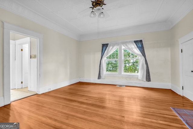 spare room with hardwood / wood-style flooring and ornamental molding