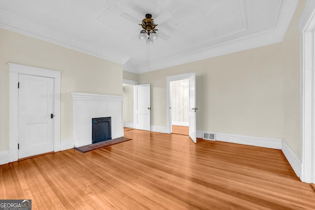 unfurnished living room featuring crown molding, ceiling fan, and light hardwood / wood-style floors