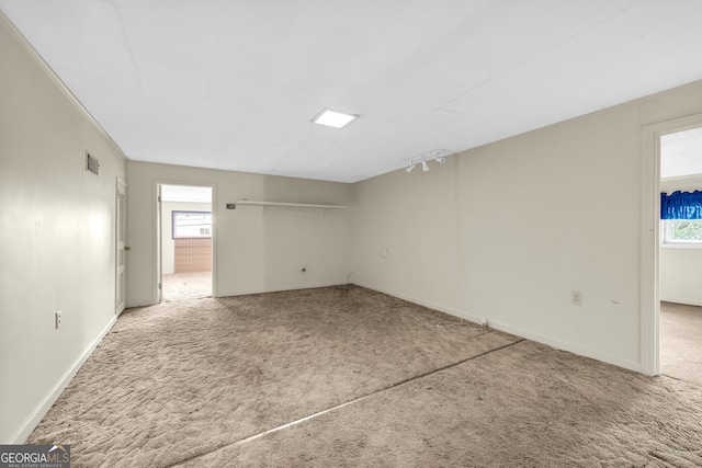 spare room with carpet and baseboards