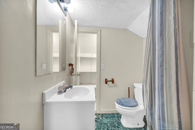 bathroom with a textured ceiling, toilet, vanity, and vaulted ceiling