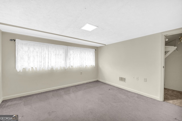 carpeted empty room with baseboards