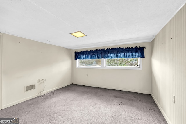 carpeted spare room featuring plenty of natural light