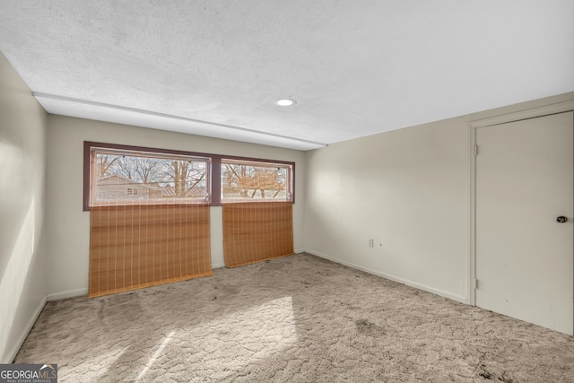 unfurnished bedroom with carpet floors, multiple windows, recessed lighting, and baseboards