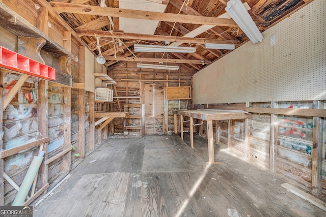 misc room with lofted ceiling and a workshop area