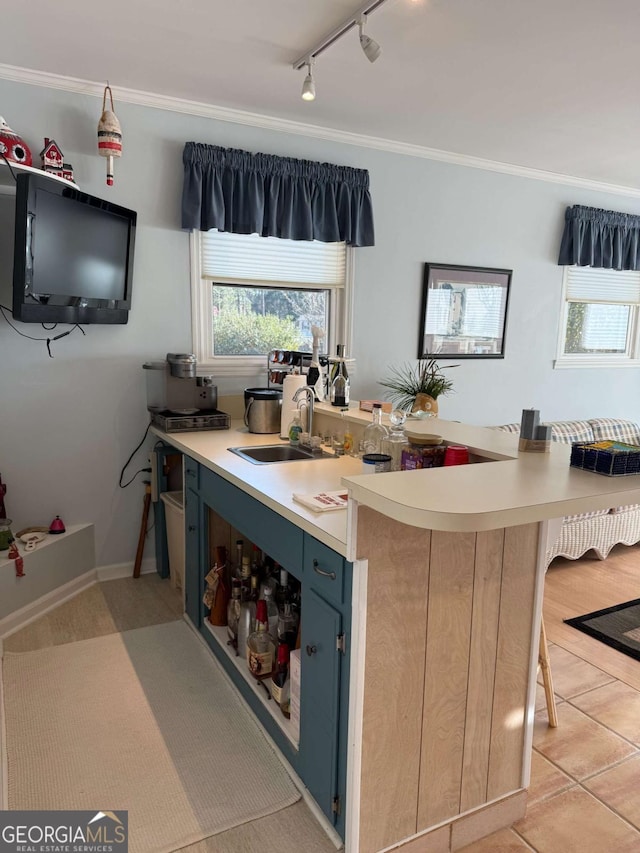 5686 Golden Isle W, Baxley, GA 31513 - kitchen featuring blue cabinetry, crown molding, light countertops, and a sink