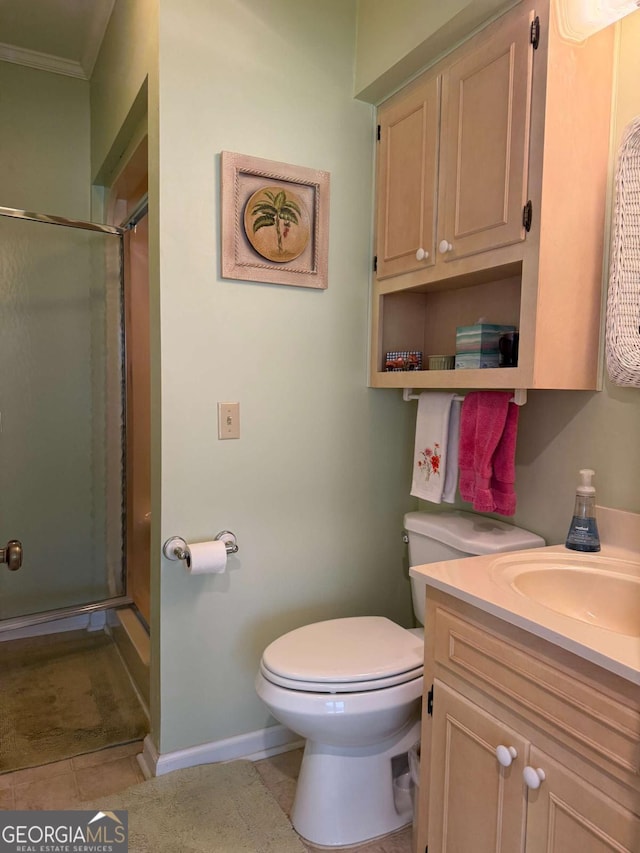 bathroom featuring a stall shower, vanity, toilet, and tile patterned floors