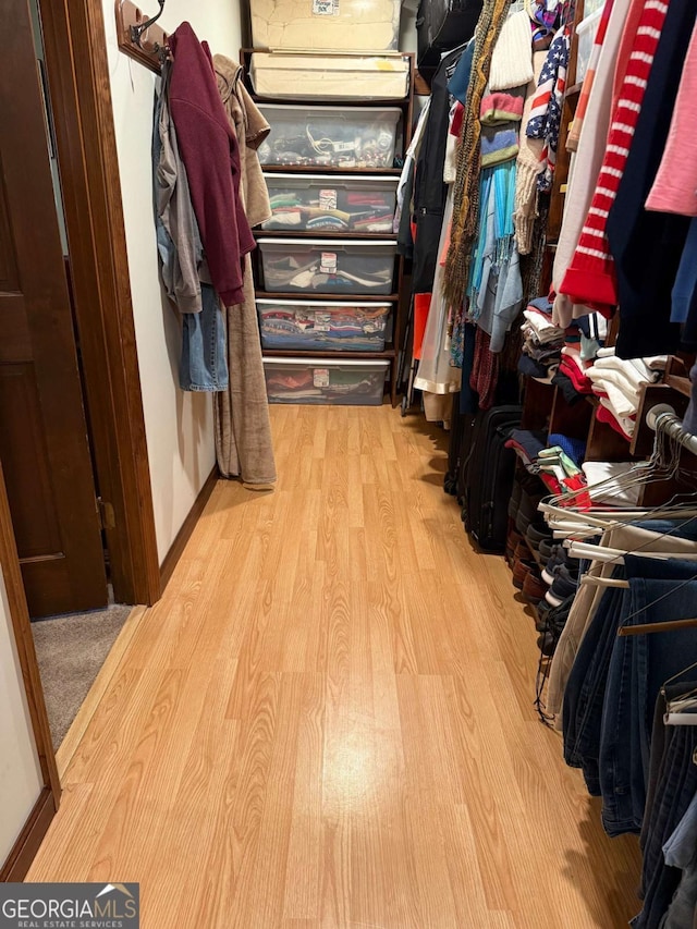 walk in closet featuring wood finished floors