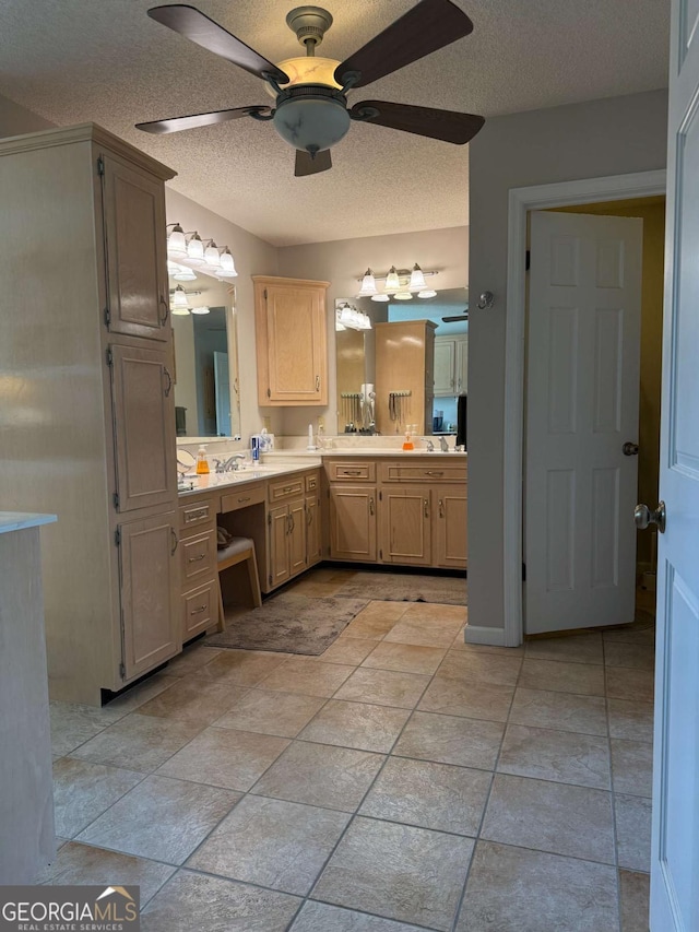 bathroom with ceiling fan, a textured ceiling, and vanity