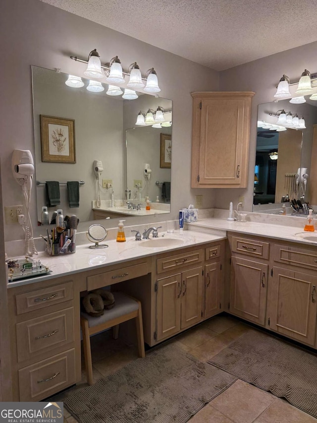 bathroom with a sink, a textured ceiling, and tile patterned floors