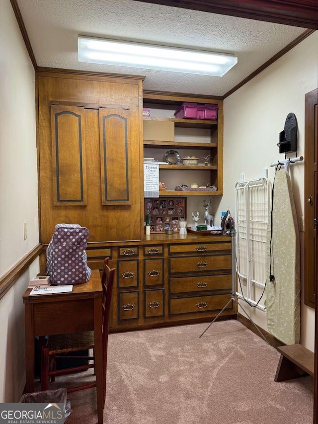 interior space featuring ornamental molding, carpet flooring, and a textured ceiling