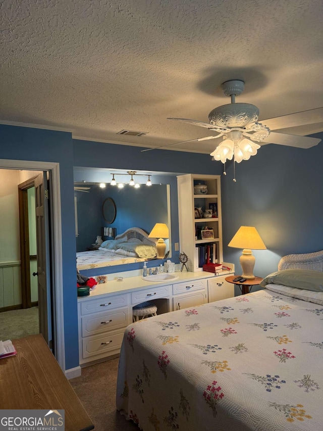 bedroom featuring visible vents, dark carpet, and a textured ceiling