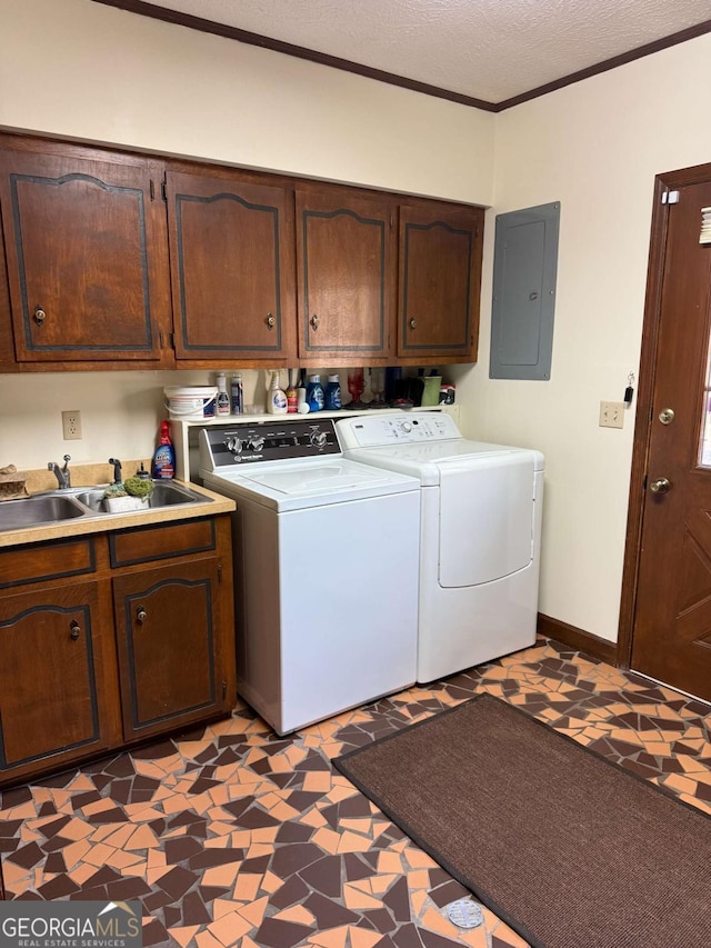 laundry room featuring washer and clothes dryer, light floors, cabinet space, a sink, and electric panel