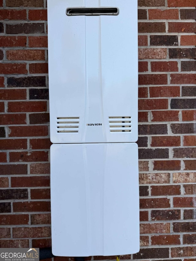 5686 Golden Isle W, Baxley, GA 31513 - exterior details with water heater and brick siding