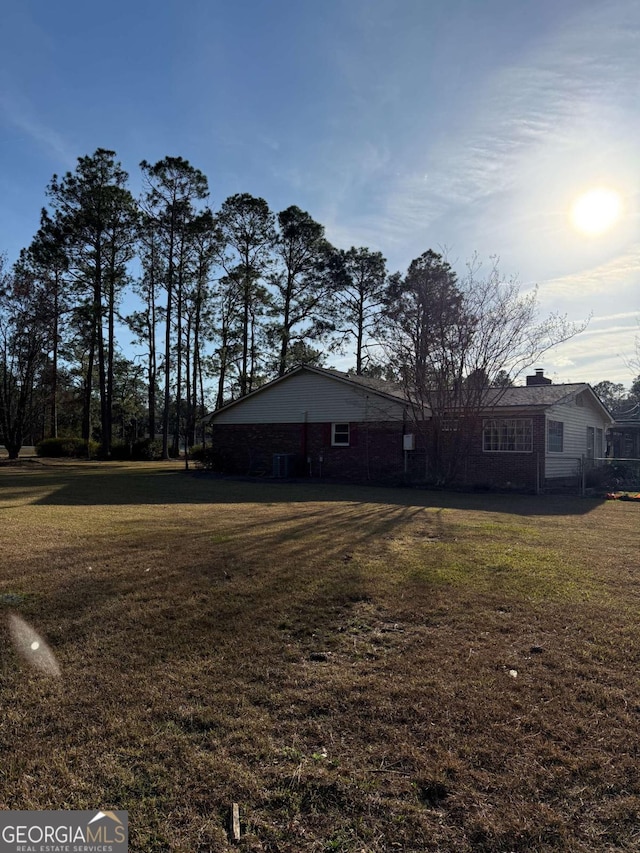 exterior space with a chimney and a front lawn