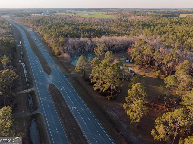 birds eye view of property with a view of trees