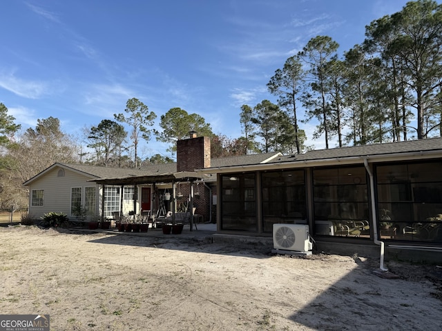 5686 Golden Isle W, Baxley, GA 31513 - back of property featuring a patio, ac unit, a chimney, and a sunroom
