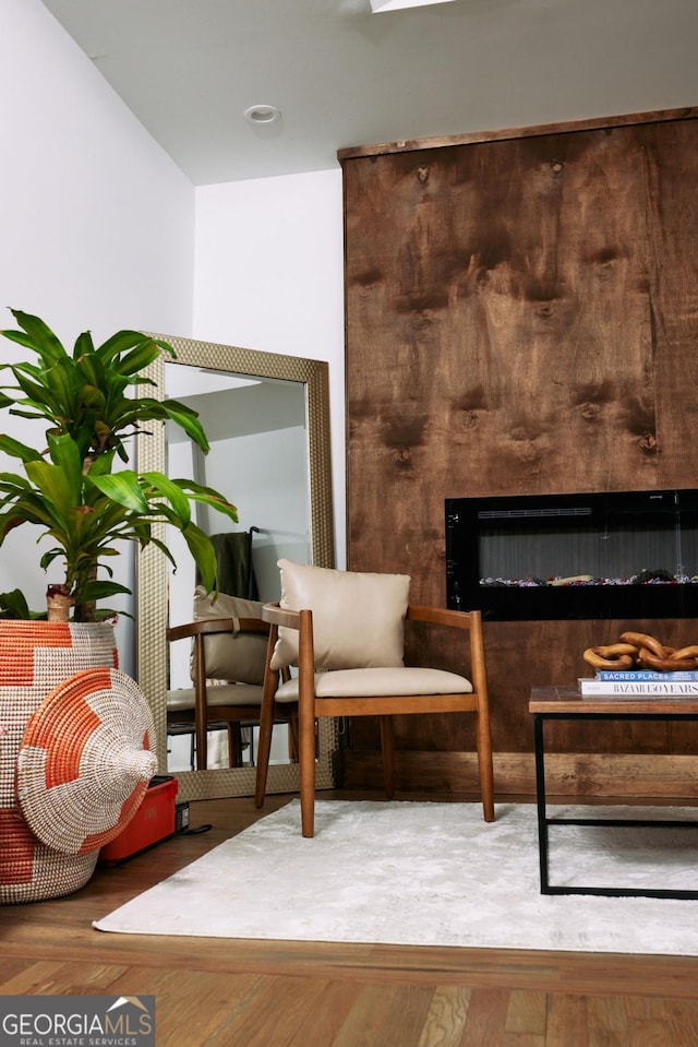 sitting room with hardwood / wood-style flooring