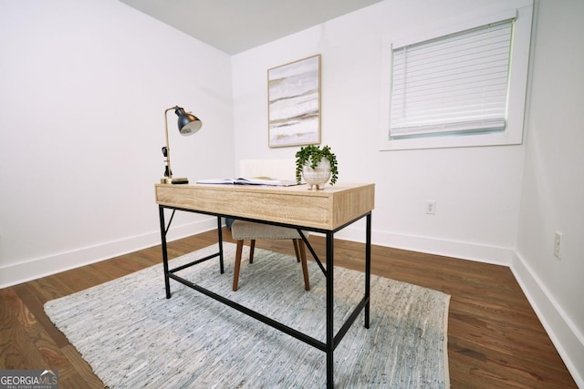 home office with dark hardwood / wood-style flooring