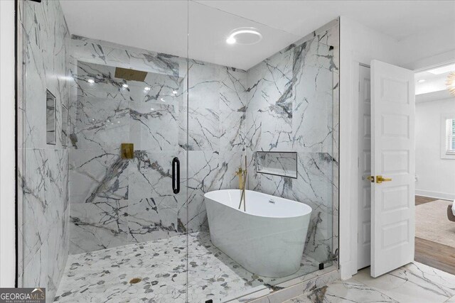 bathroom with shower with separate bathtub