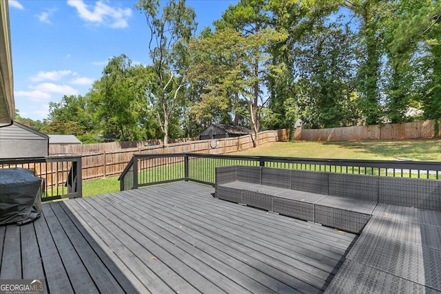 wooden terrace featuring a lawn