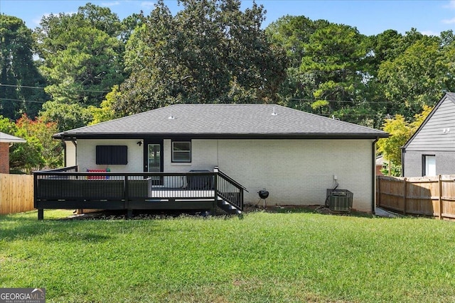 back of house with a yard, cooling unit, and a deck