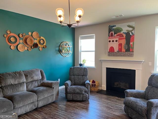 living room featuring hardwood / wood-style floors and a notable chandelier