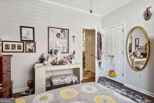 bedroom with a closet, ornamental molding, and wood-type flooring