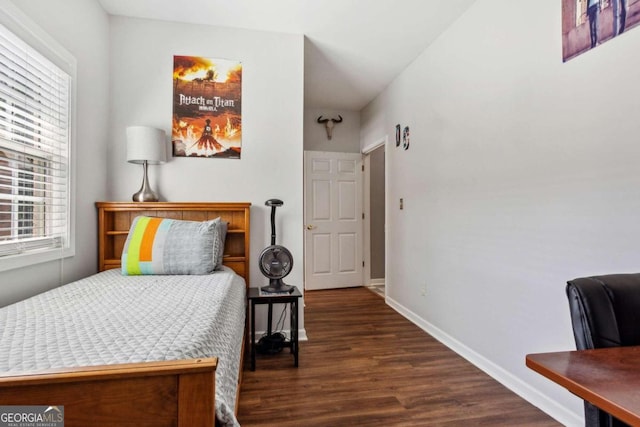 bedroom with dark hardwood / wood-style flooring