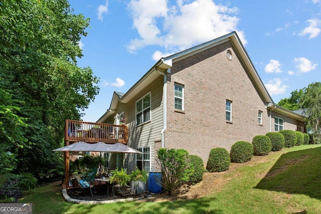 view of side of home with a yard