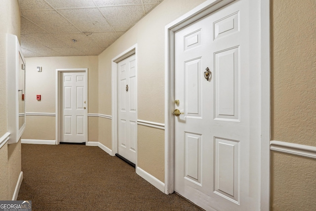 hallway with dark carpet