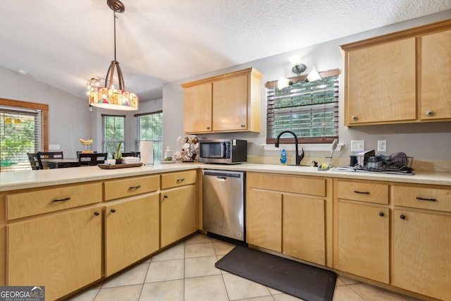 kitchen featuring light tile patterned flooring, light brown cabinetry, sink, hanging light fixtures, and stainless steel appliances