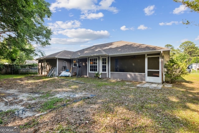 rear view of property with a sunroom