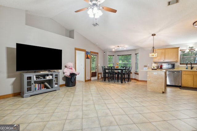 kitchen featuring lofted ceiling, decorative light fixtures, light tile patterned floors, dishwasher, and a healthy amount of sunlight