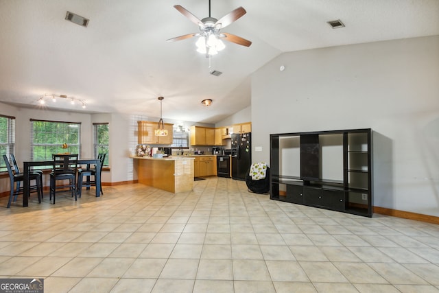 kitchen featuring lofted ceiling, black appliances, light tile patterned flooring, decorative light fixtures, and kitchen peninsula